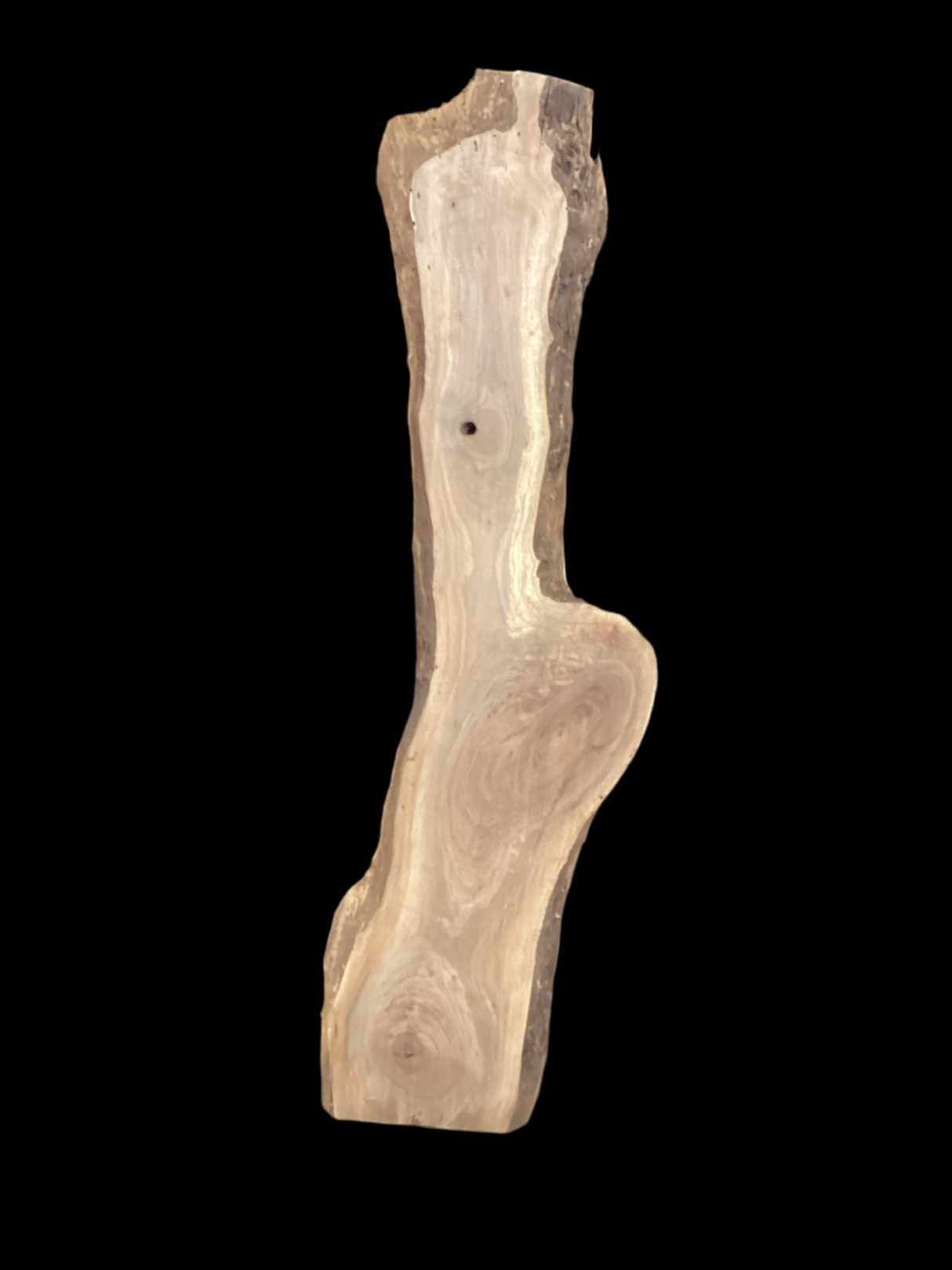 A long walnut slab with a black background.