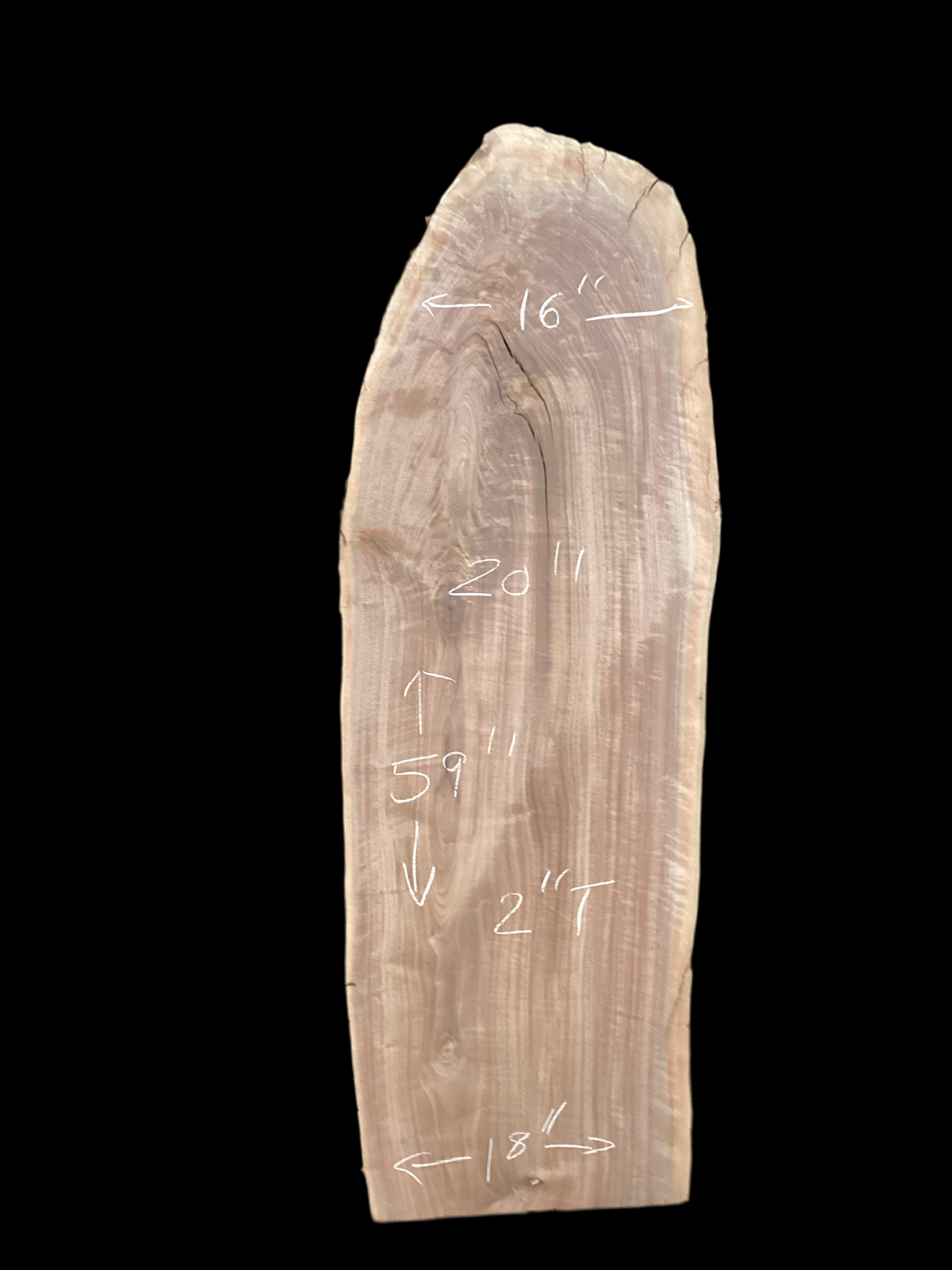 A short walnut slab with a black background.