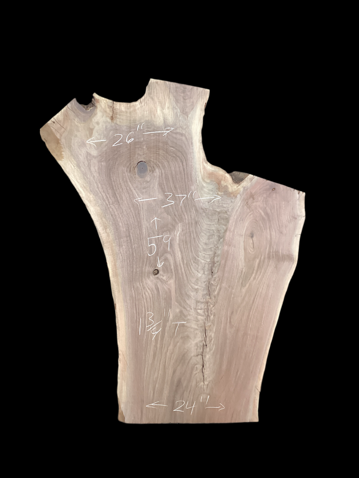A short irregular shaped walnut slab with a black background.