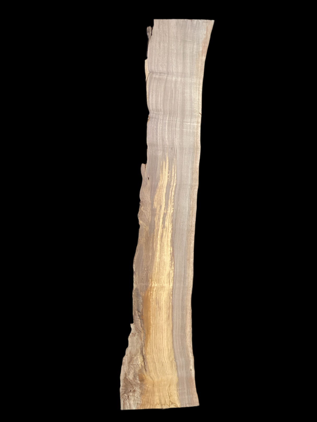 A long walnut slab with a black background.