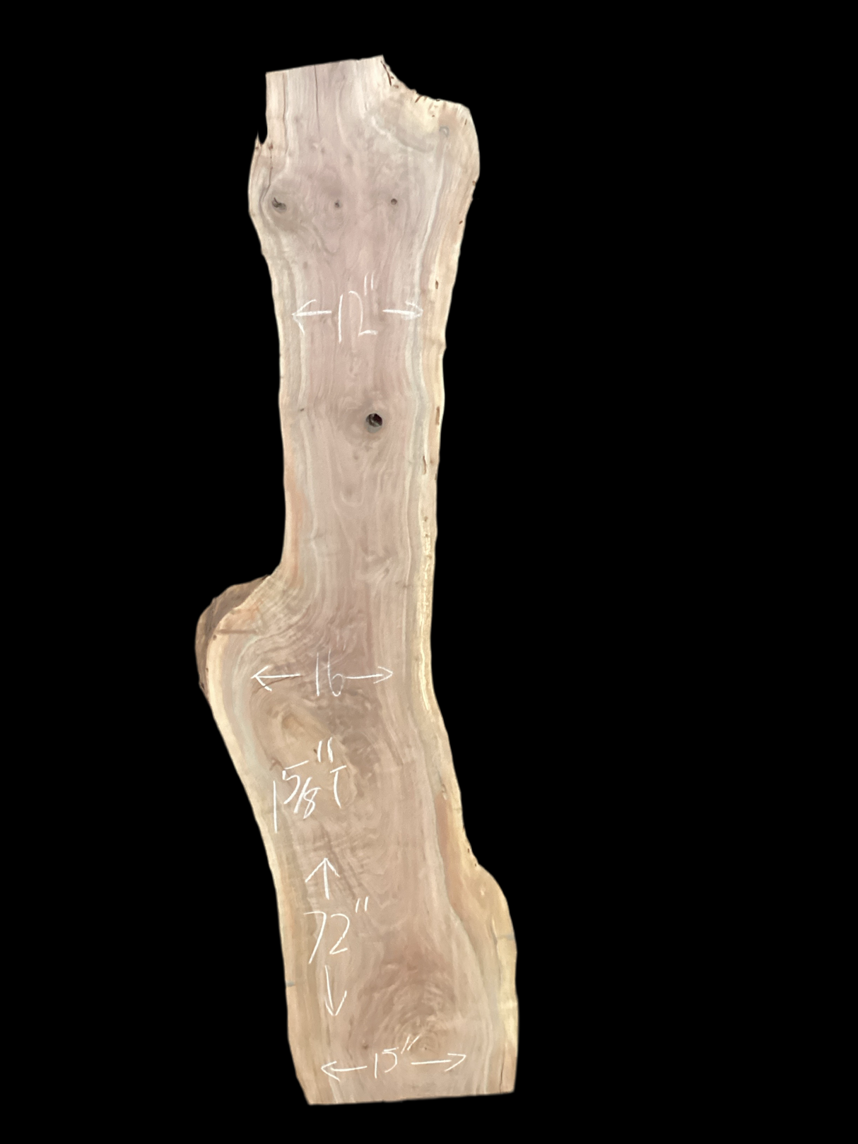 A long walnut slab with a black background.