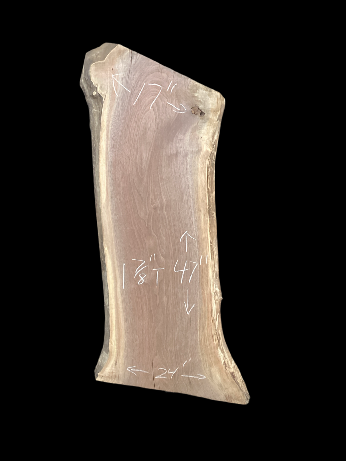 Walnut wood slab with a black background.