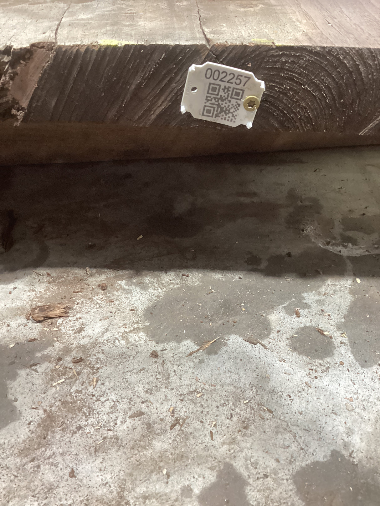 A rough, rectangular walnut wood slab with a tiger striped grain pattern, bearing a QR code with the product number '2257'.