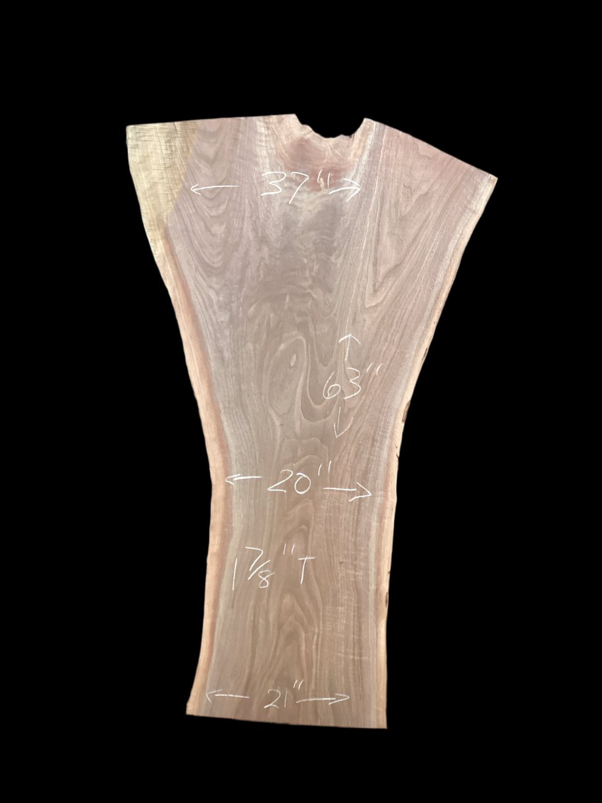 A large walnut slab with a black background.