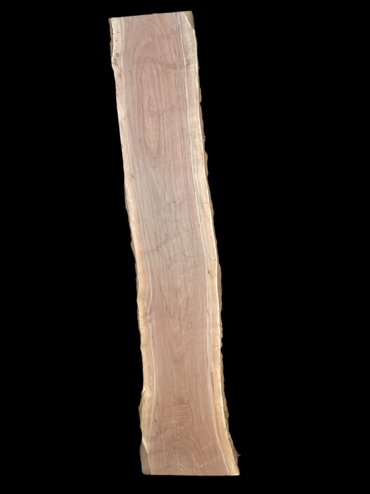 A long walnut wood slab on a black background.