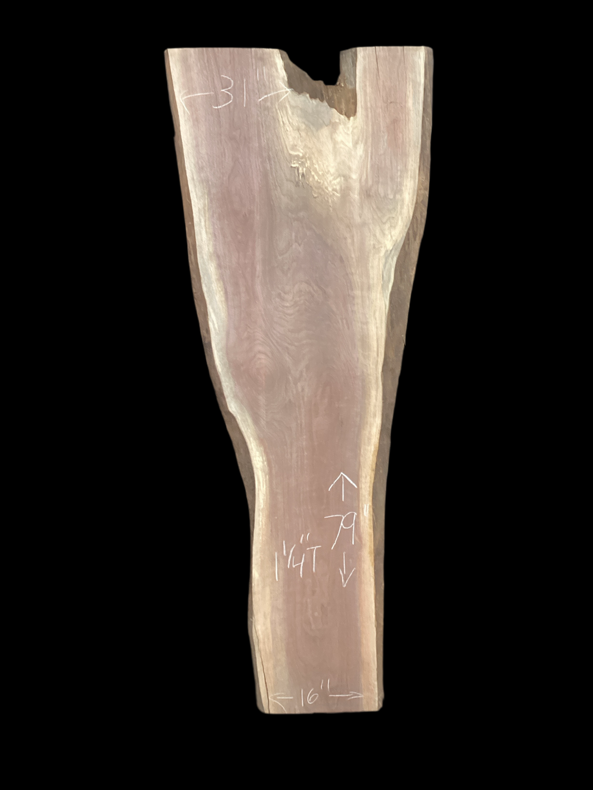 A long walnut slab, wider on one end than the other and on a black background.