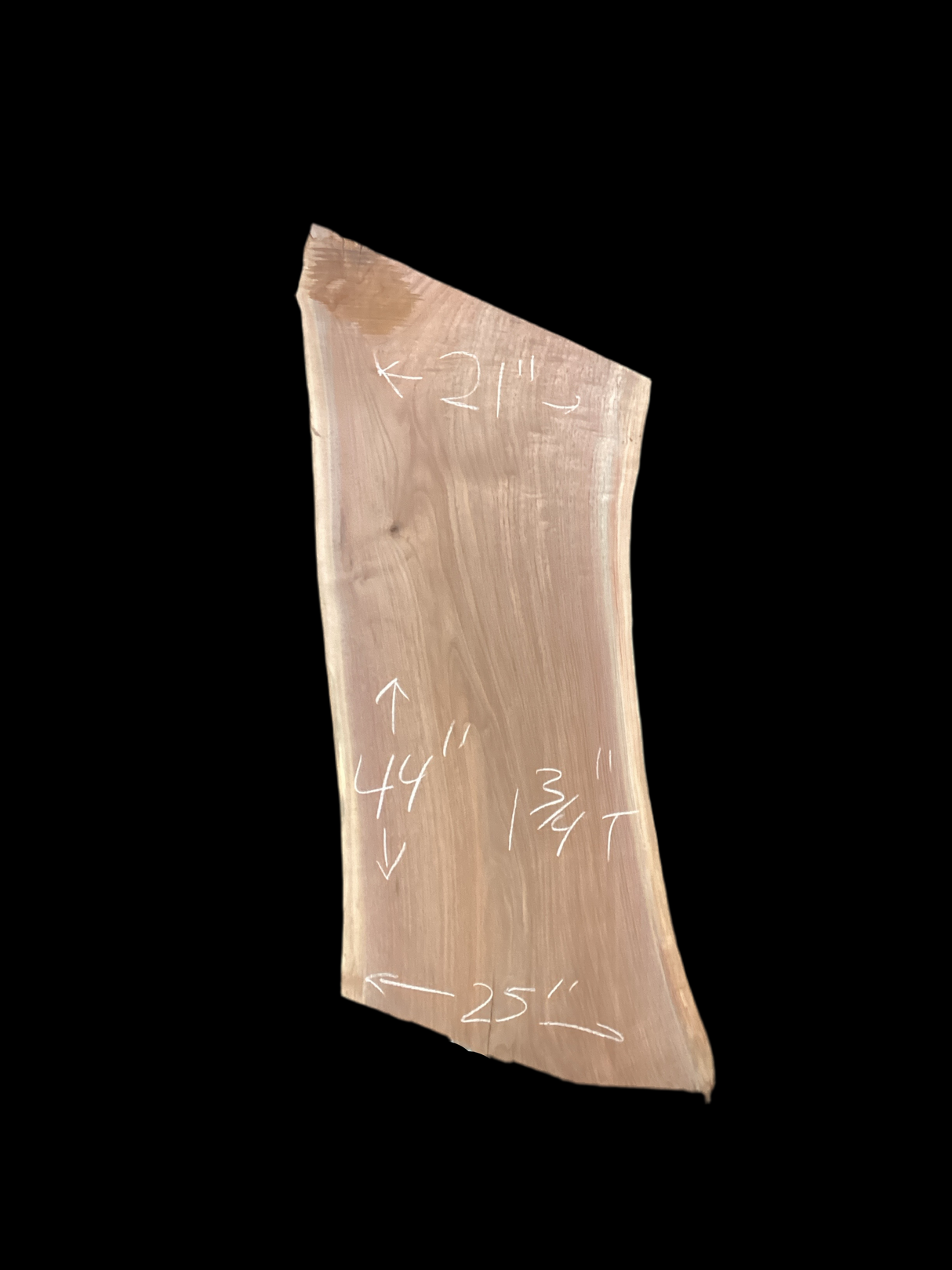 Walnut wood slab with a black background.