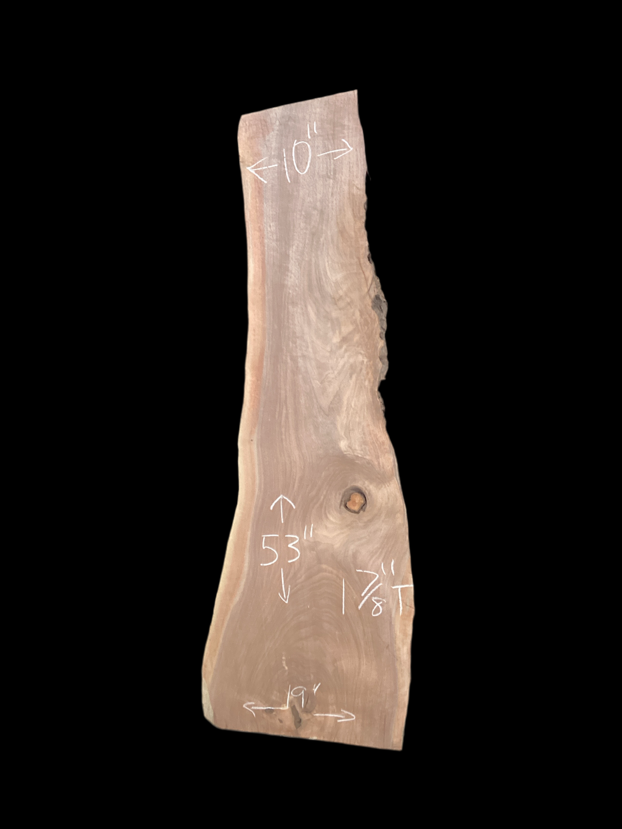 A short walnut slab with a black background.