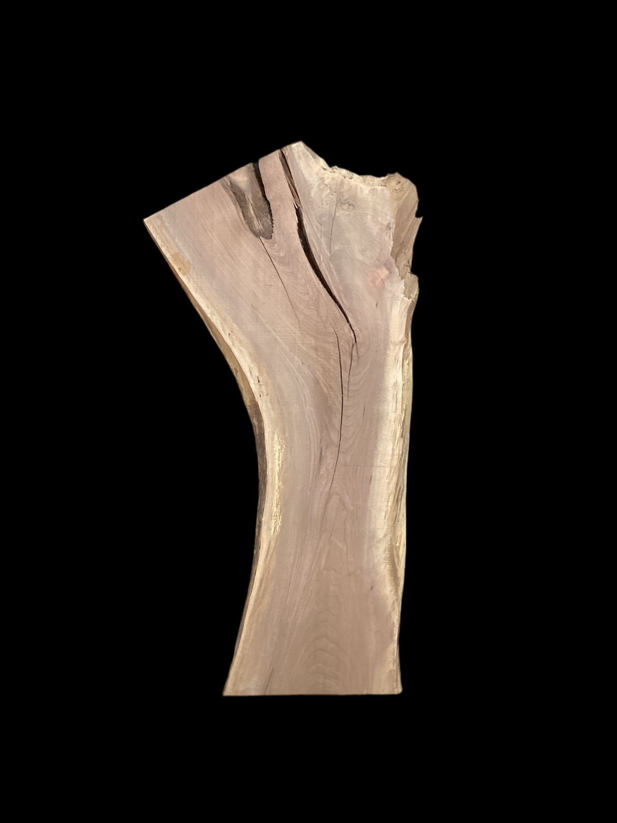 A long walnut slab with a black background.