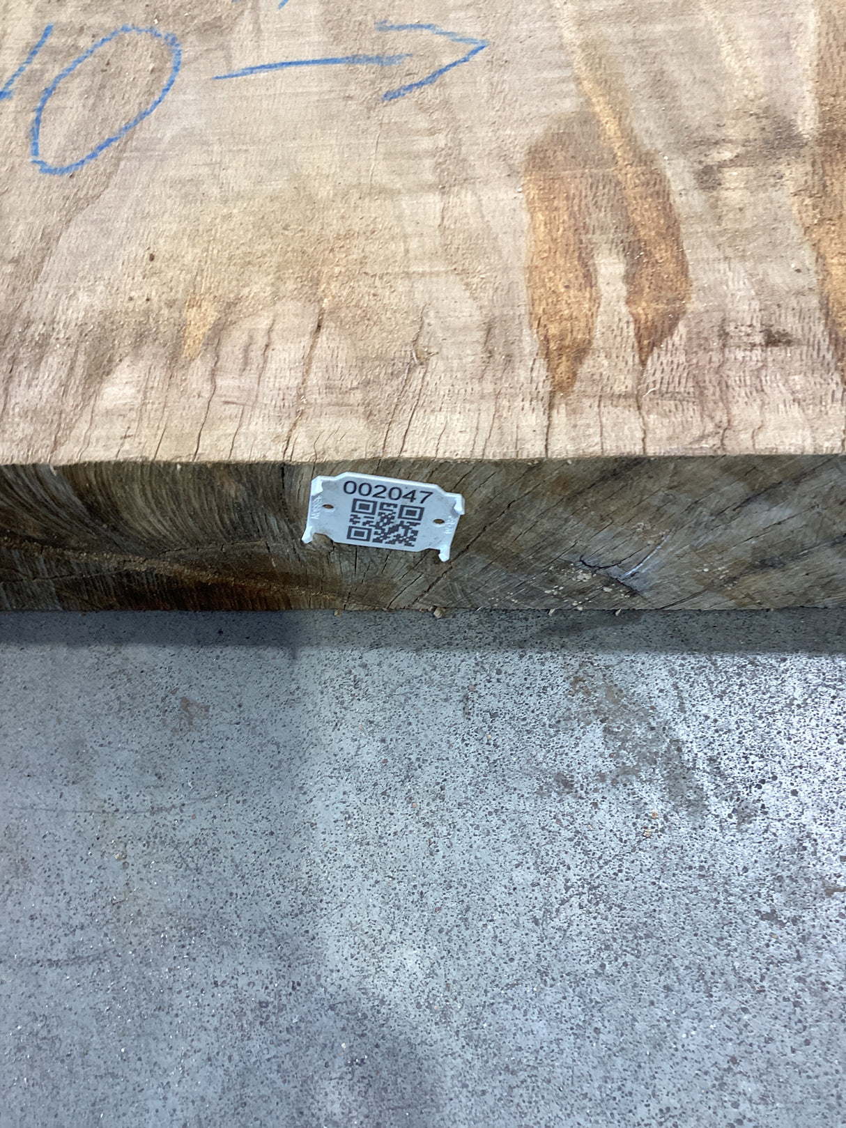 QR label attached to the edge of a red oak slab.