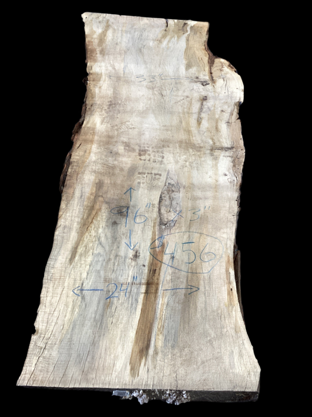 Silver Maple slab showcases distinctive grain patterns and natural character on a black background.