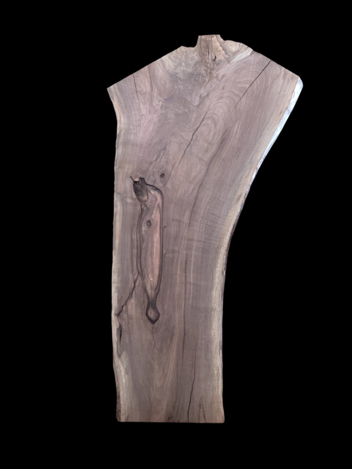 A walnut slab with a black background.