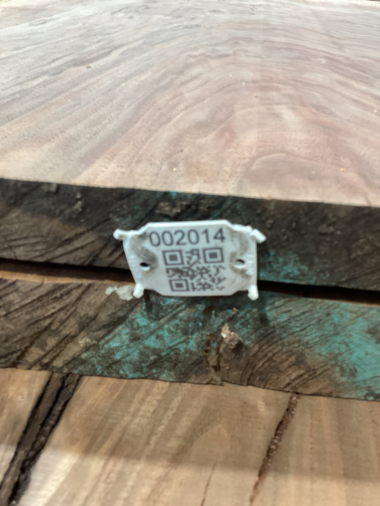 QR label attached to a walnut wood slab edge.