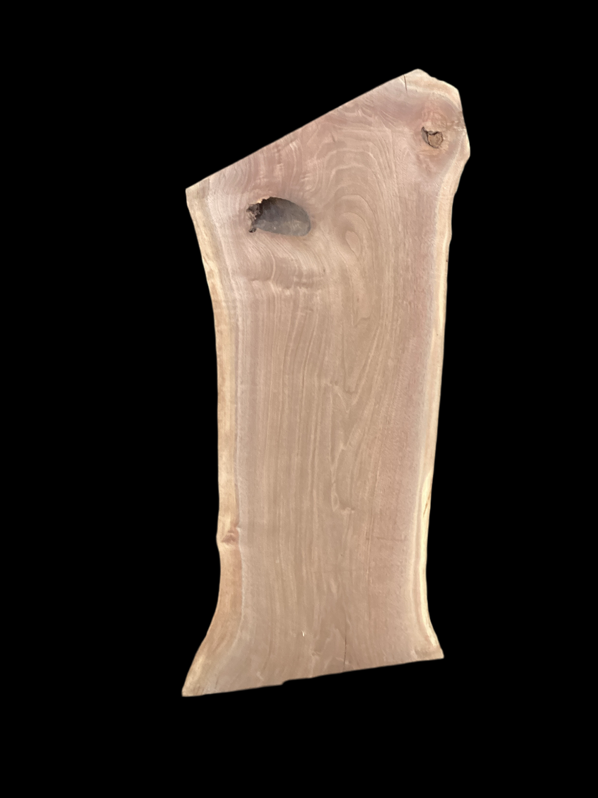 Walnut wood slab with a black background.