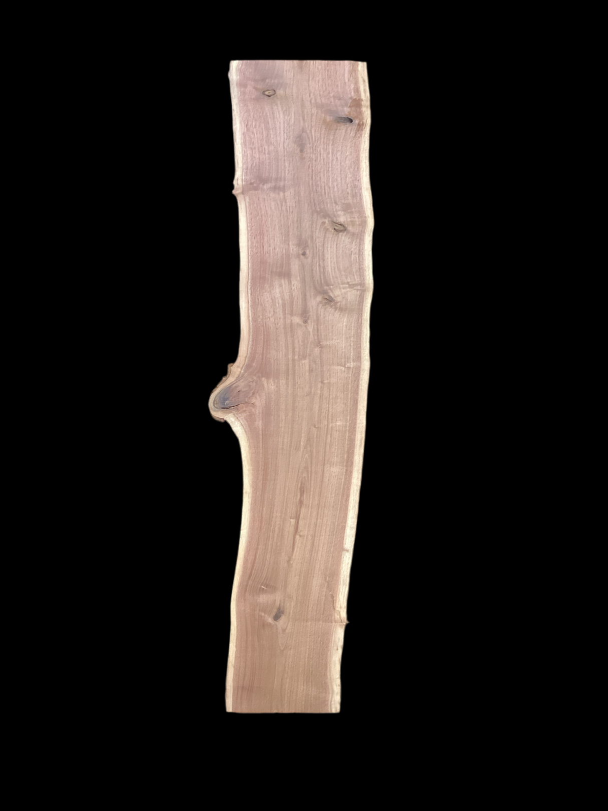 Large walnut wood slab with a black background.