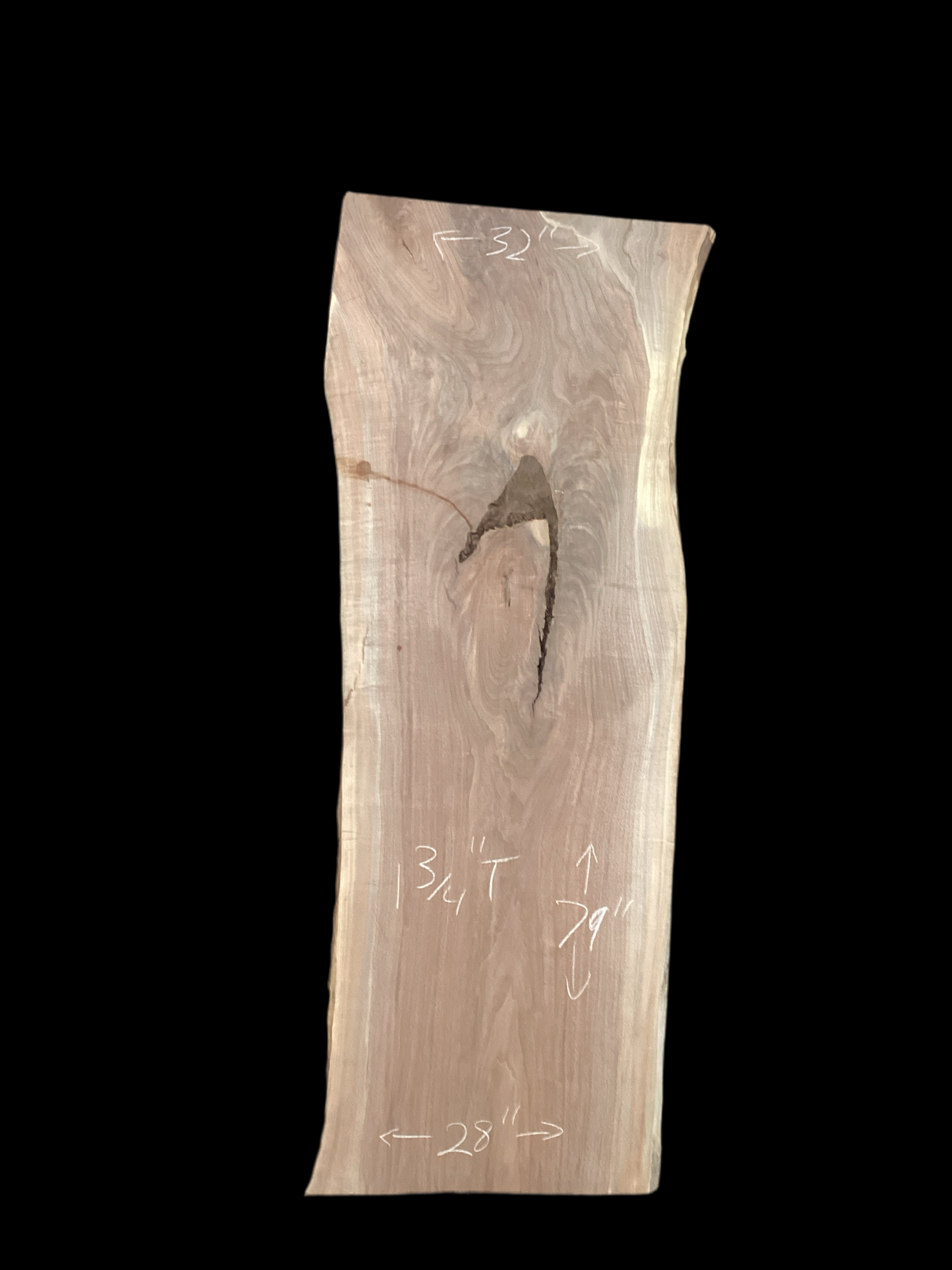 A short walnut slab with a black background. 