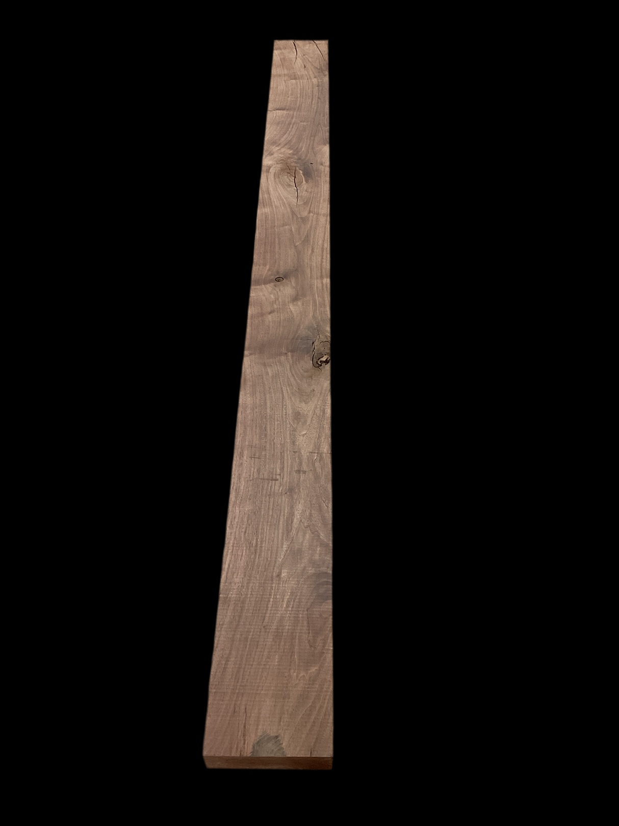 A walnut fireplace mantle with a natural finish, displaying the grain and color of the walnut wood.