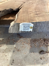 QR label attached to the edge of a walnut wood slab.