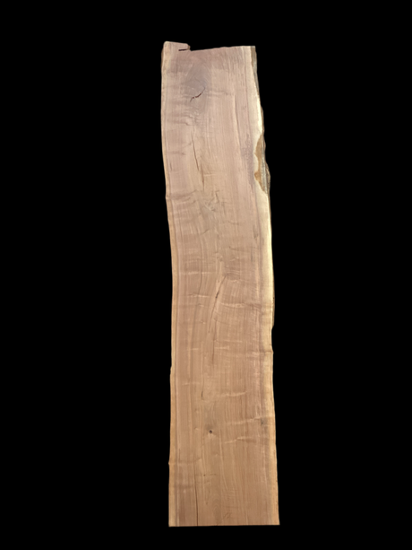 A long walnut wood slab on a black background.