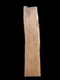 A long walnut wood slab on a black background.
