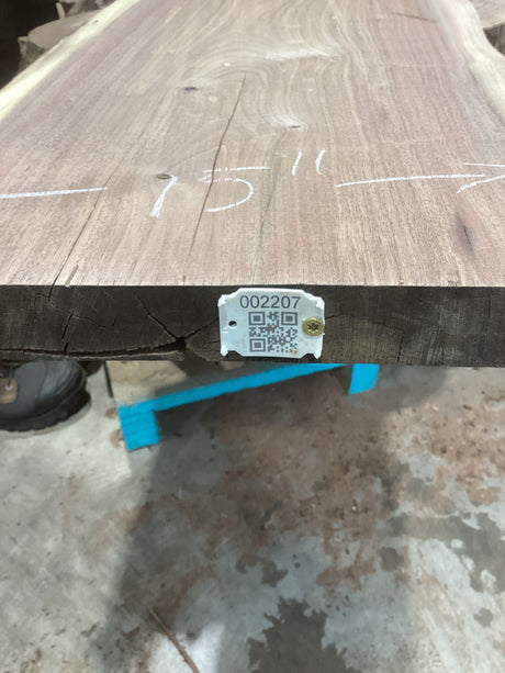 A walnut wood slab with visible unique patterns and natural imperfections, marked with a measurement '1516' and a QR code.