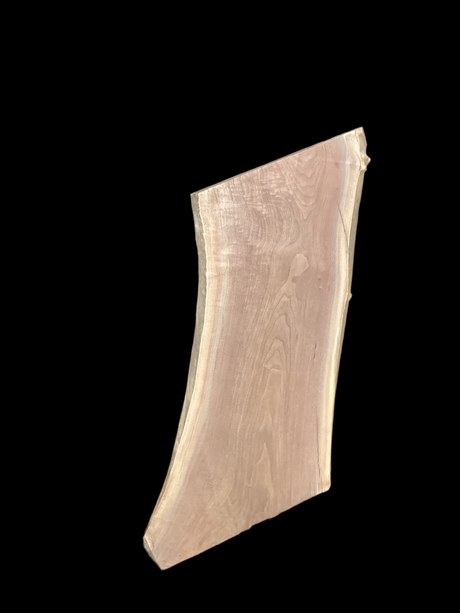 Walnut wood slab with a black background.