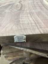 A walnut wood slab with a visible wood grain pattern and a QR tag attached to it.