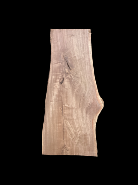 A large walnut slab with a black background.