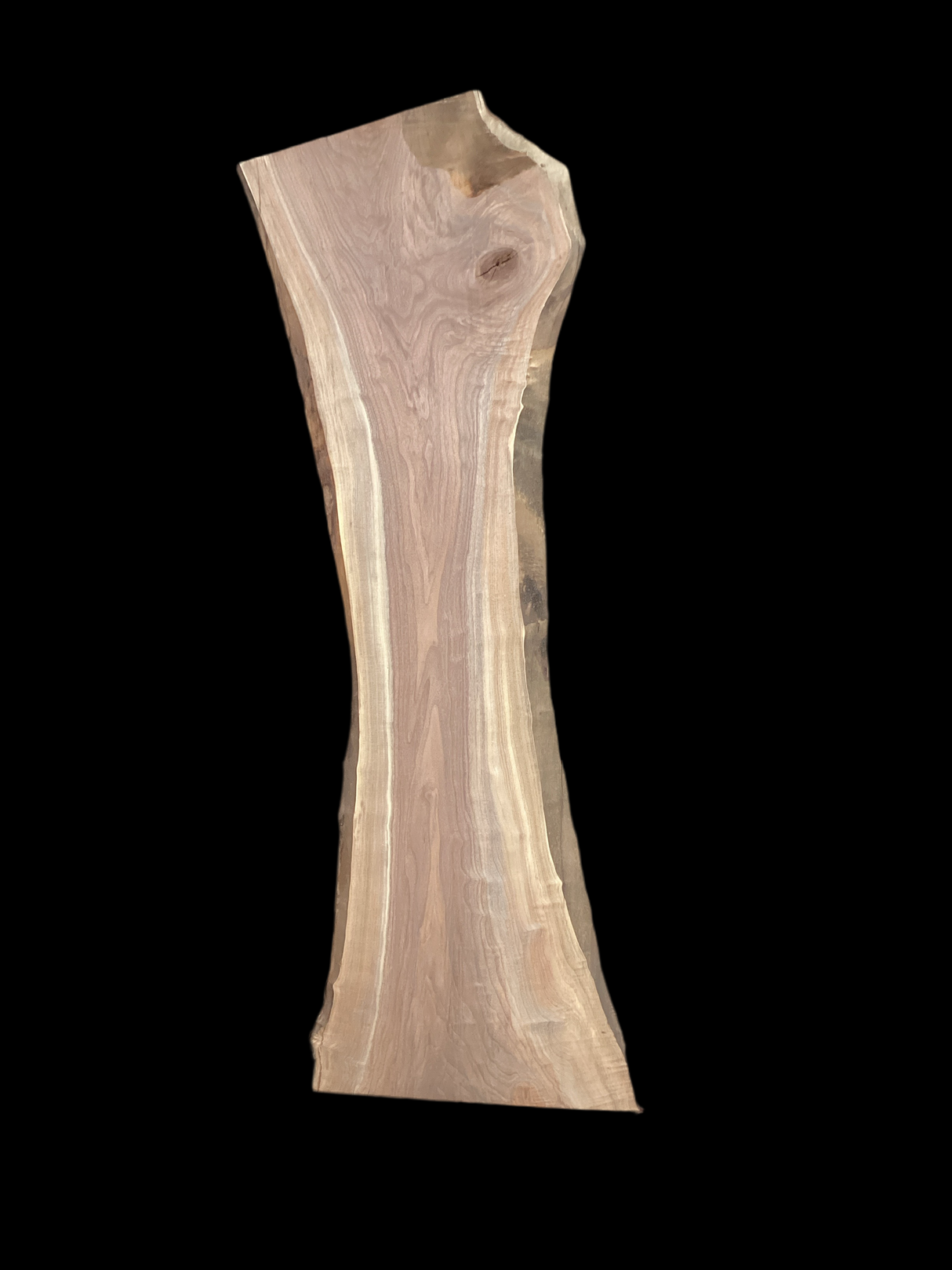 A short walnut slab with a black background. 