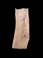 A large walnut slab with a black background.