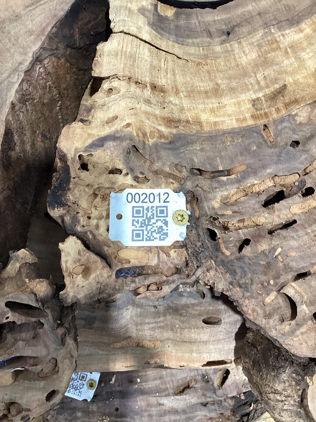 QR label attached to walnut wood slab.