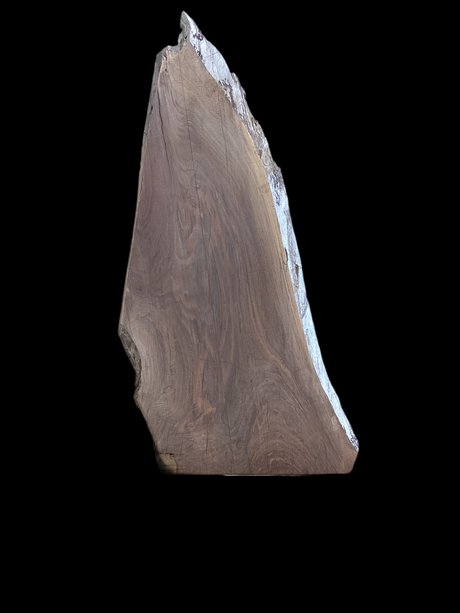 A large walnut wood slab with a visible natural grain and a finished edge on a black background.