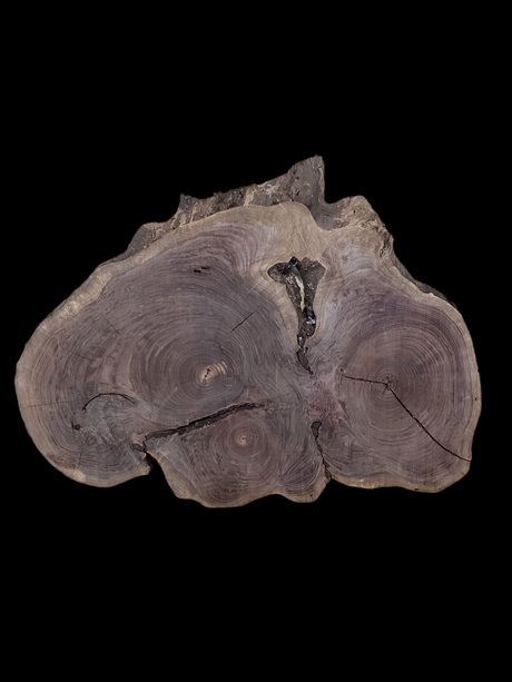 A unique, round walnut coffee table with three distinct heart-shaped centers, each displaying a different grain pattern.