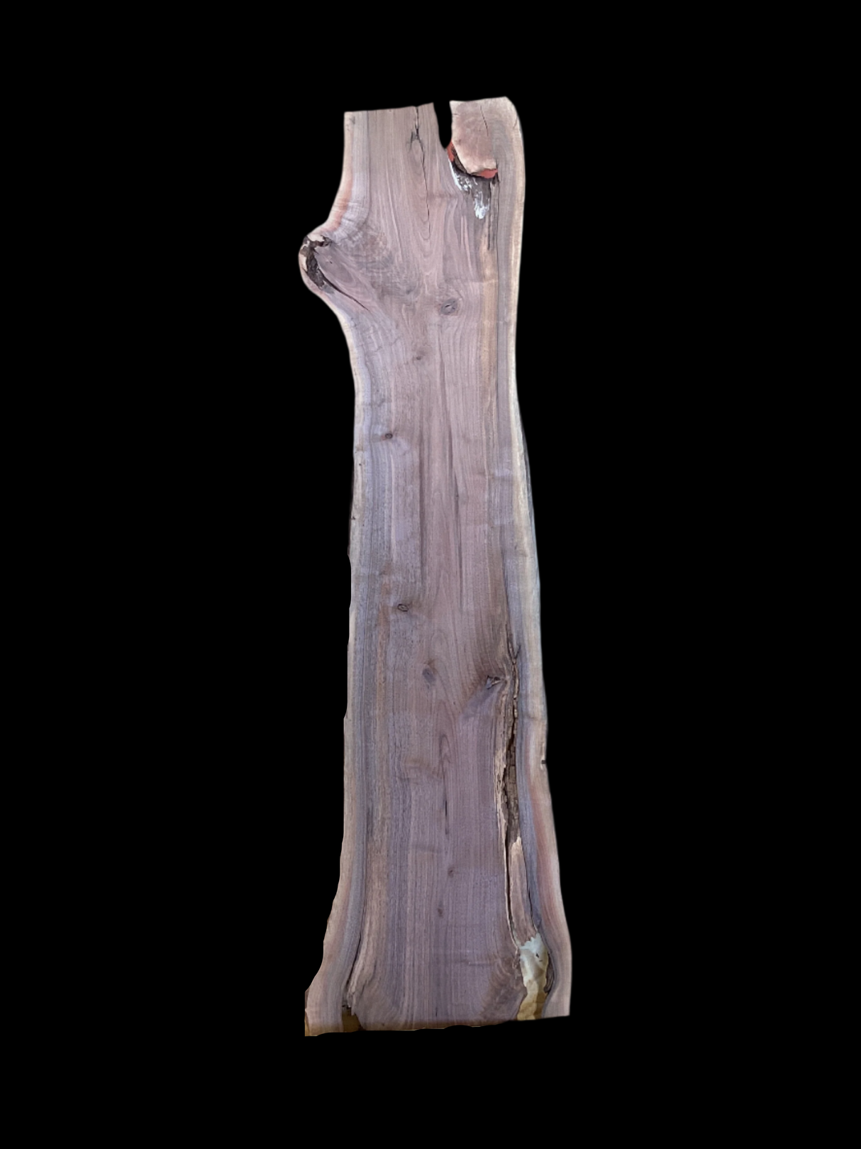 A walnut wood slab with a natural brown finish on a black background.