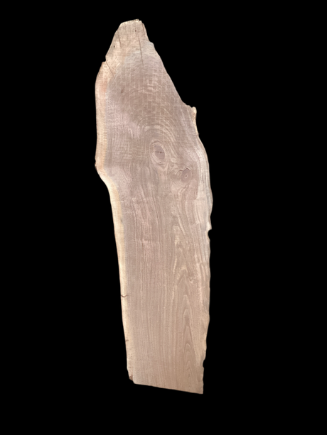 Large walnut wood slab with a black background.