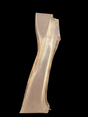 A long walnut slab on a black background. 