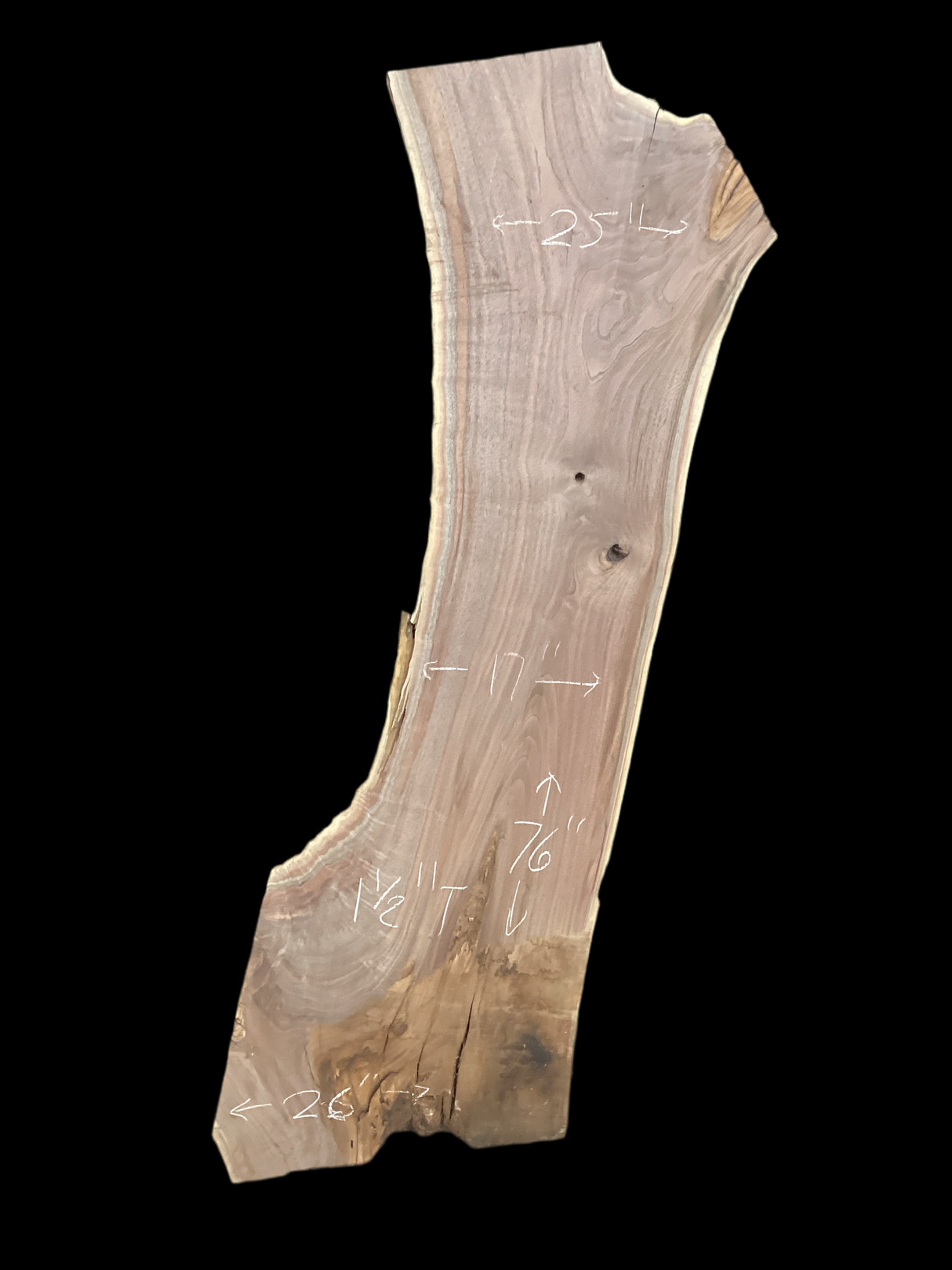 A short walnut slab with a black background.