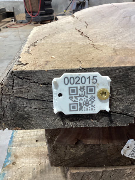 QR label attached to a walnut wood slab.