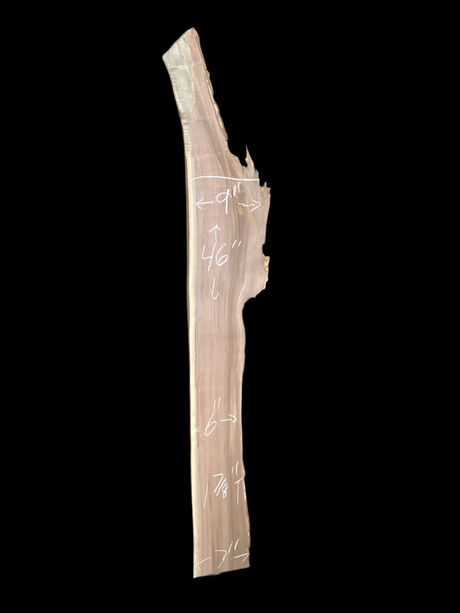 Large, narrow walnut wood slab with a black background.