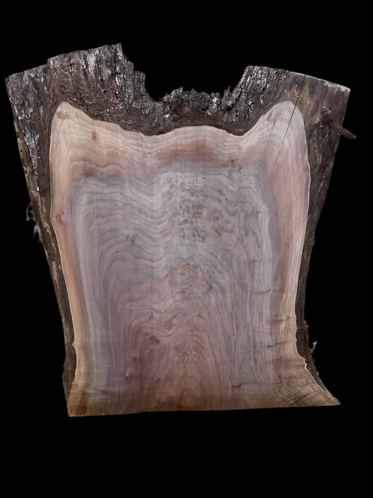 A close-up image of a walnut slab with a tiger-striped figure, indicating the natural grain of the wood.