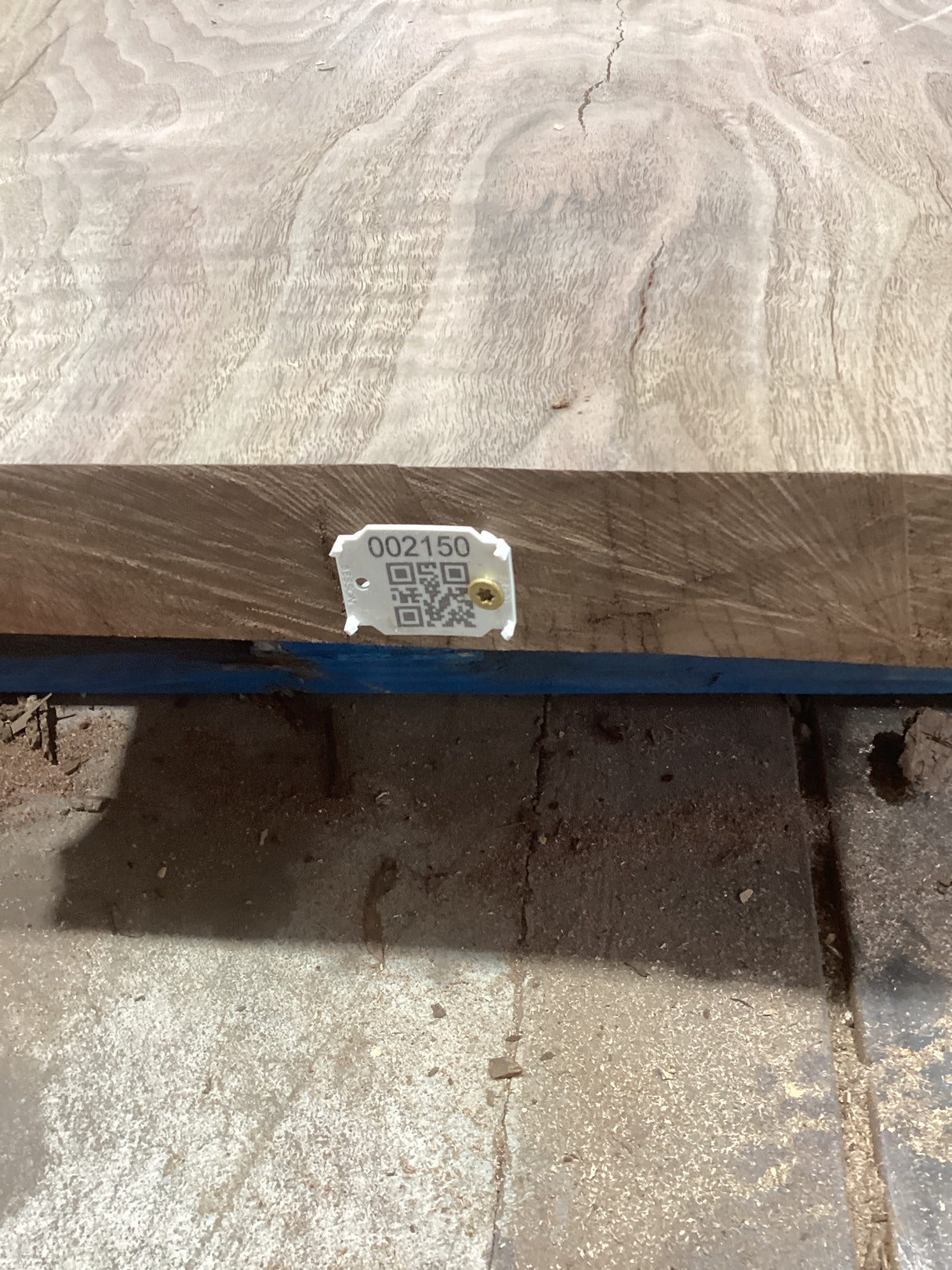 A small rectangular walnut wood coffee table with a visible grain pattern and a QR label attached to the side.