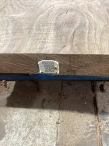 A small rectangular walnut wood coffee table with a visible grain pattern and a QR label attached to the side.