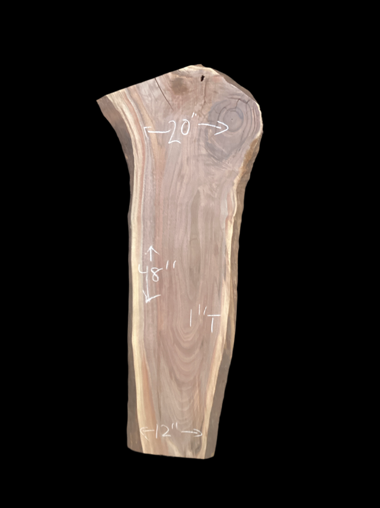 Walnut wood slab with a black background.