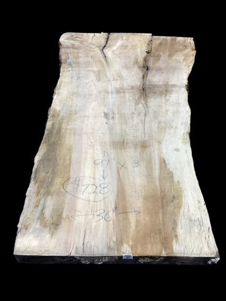 Silver Maple slab showcases distinctive grain patterns and natural character on a black background.