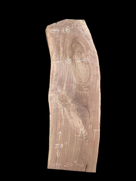 A short walnut slab with a black background.