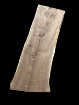 Large walnut wood slab with a black background.
