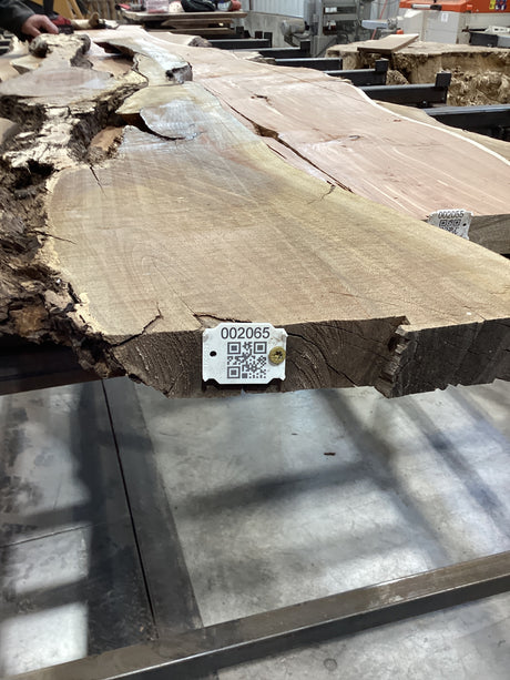 QR label attached to the edge of the walnut slab.