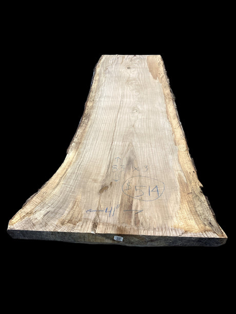 A beige-colored, solid-wood red oak slab with marked dimensions on it, indicating its size and shape.