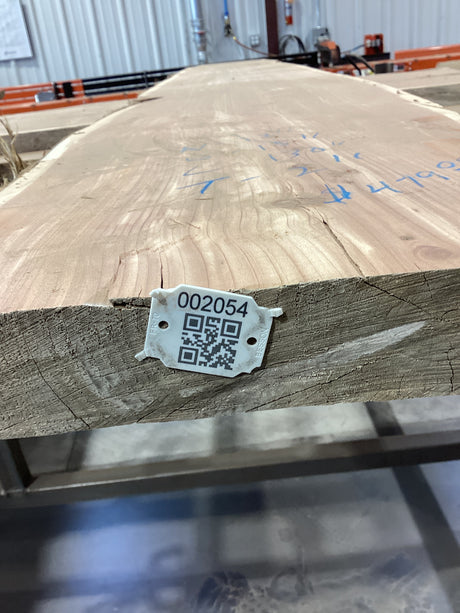 QR label attached to the edge of the wood slab.