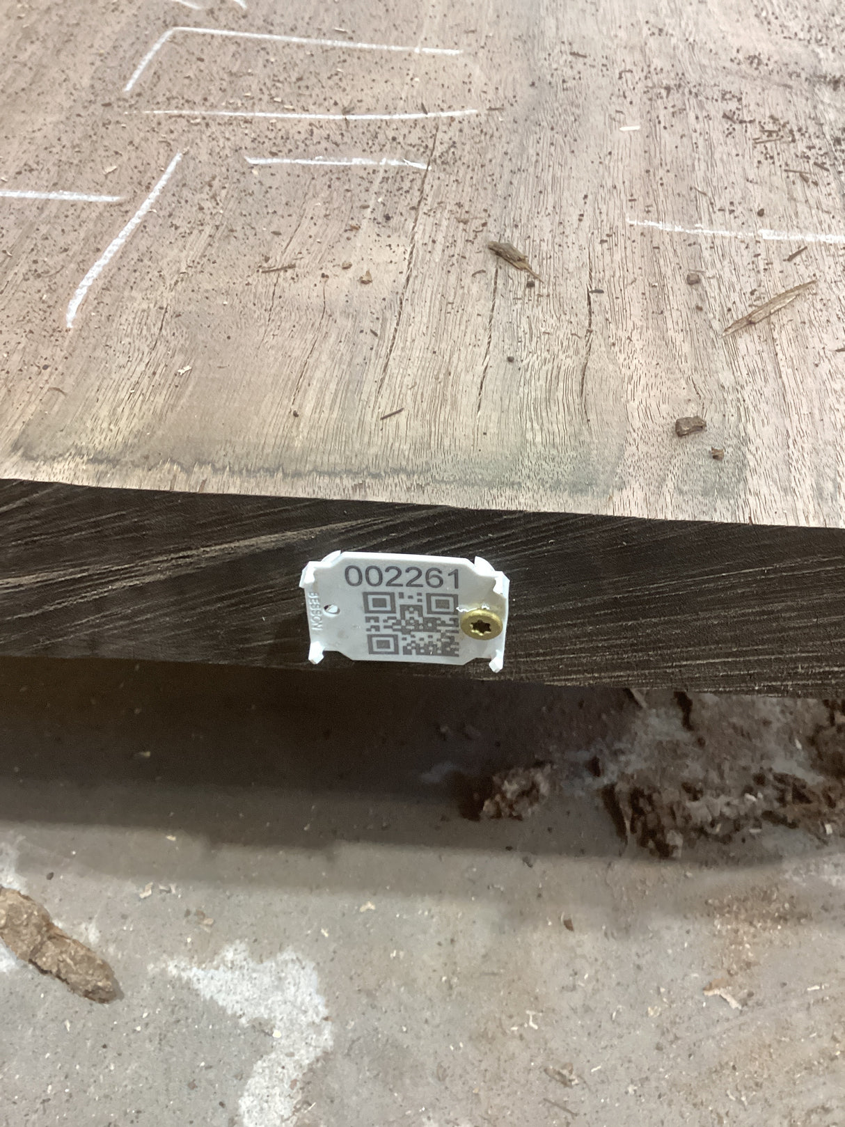 A walnut wood slab with a label that includes the identification number 002261.